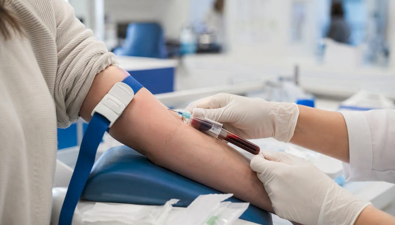 Phlebotomist drawing blood for zinc test